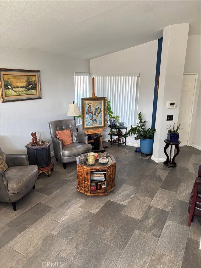 2830 Chuckwagon Road Palmdale, CA 93550 - Photo 11 of 11 a living room with furniture and a large window