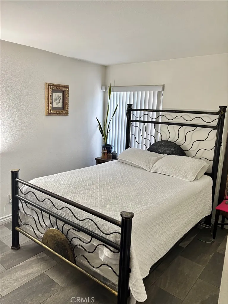 2830 Chuckwagon Road Palmdale, CA 93550 - Photo 7 of 11 a bedroom with a bed and a table