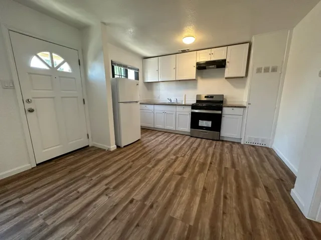 a kitchen with stainless steel appliances a refrigerator and a stove top oven