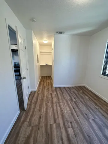 a view of a room with wooden floor and staircase