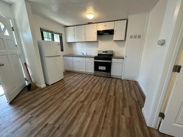 a kitchen with white cabinets and stainless steel appliances