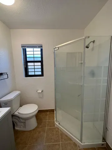 a bathroom with a toilet and a shower
