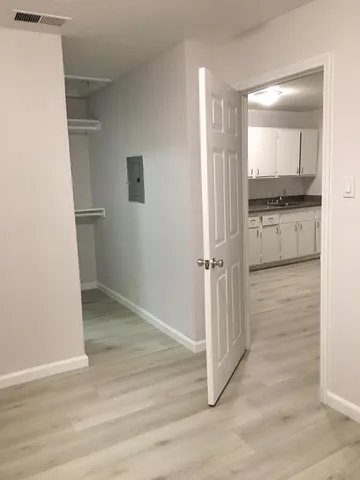 a view of a kitchen from a hallway