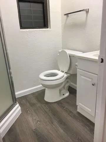 a bathroom with a toilet and a shower