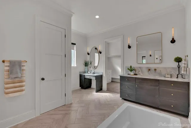 a spacious bathroom with a double vanity sink a mirror a bathtub and shower