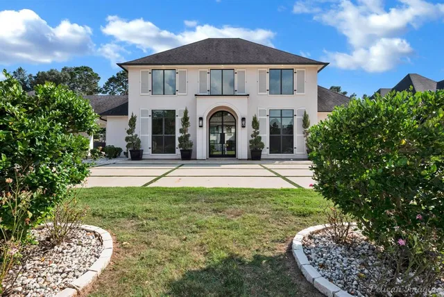 a front view of a house with garden