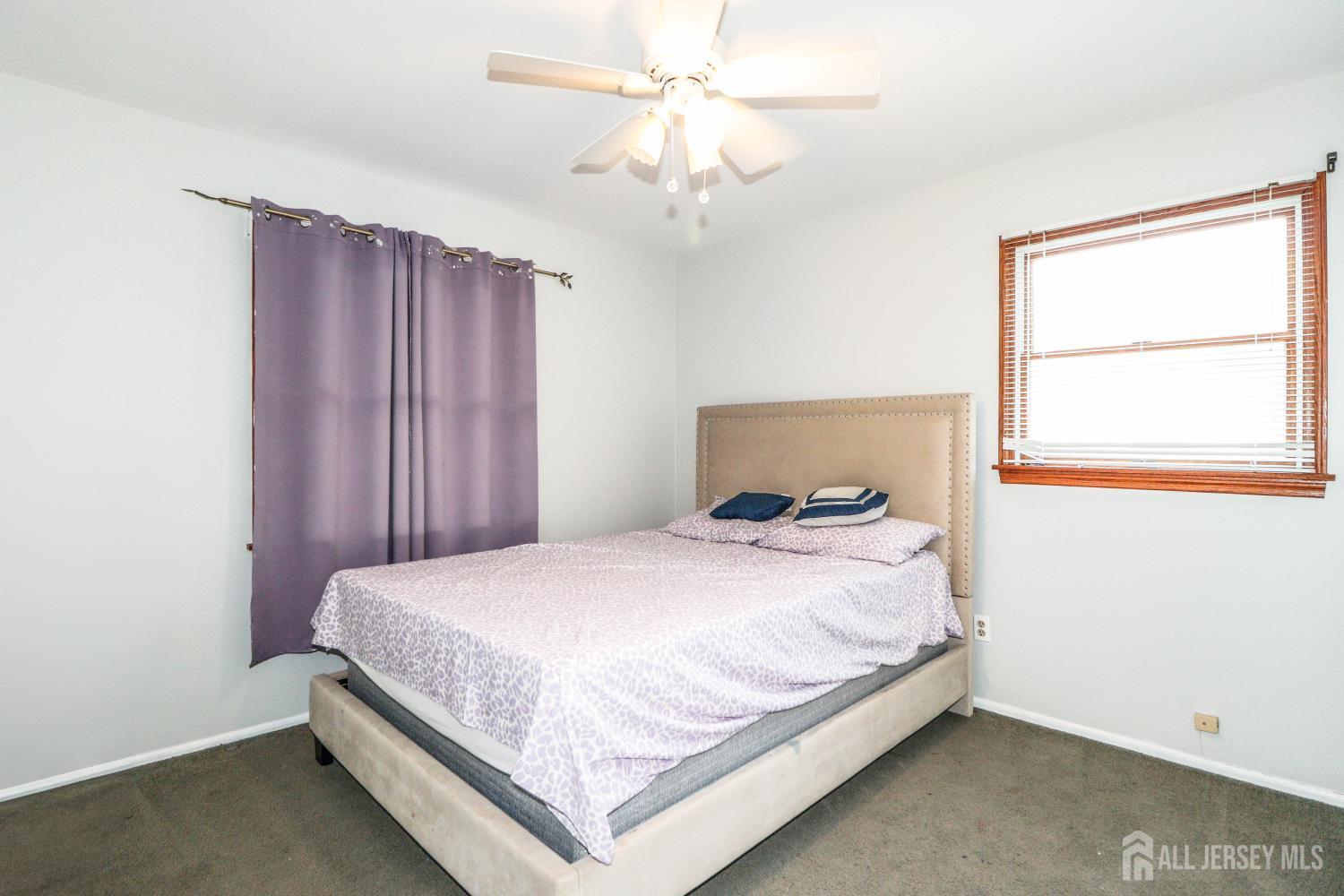 5 Timothy Court Edison, NJ 08837 - Photo 19 of 32 a bedroom with a bed and a chandelier