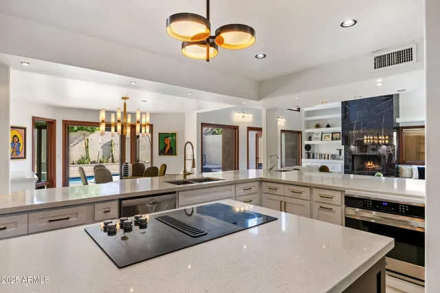 a kitchen with furniture a sink and stainless steel appliances