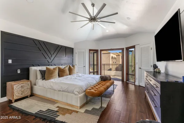 a bedroom with a bed and a flat screen tv