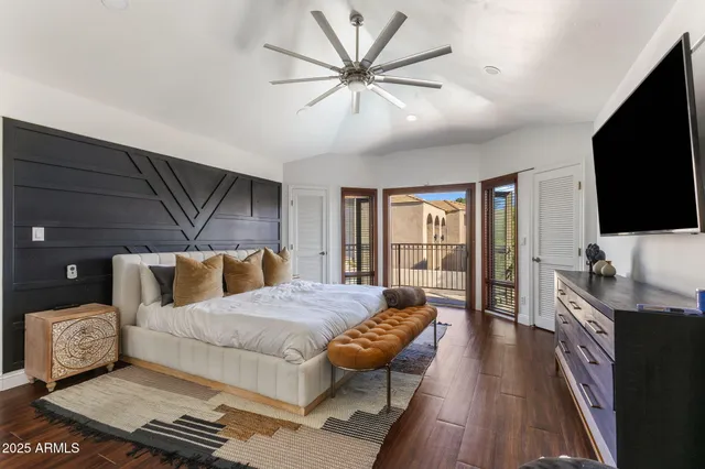 a bedroom with a bed and a flat screen tv