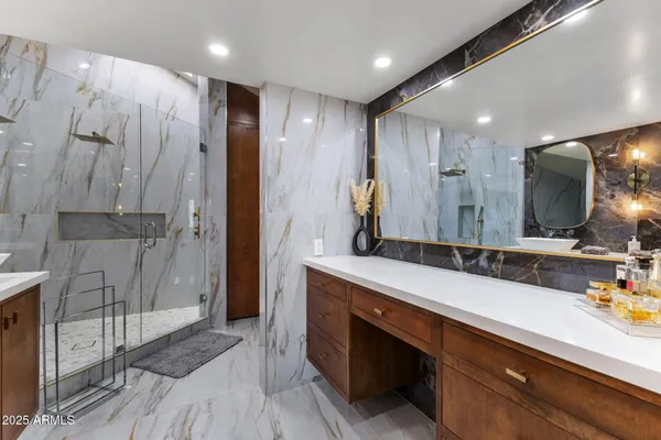 a bathroom with a double vanity sink and a mirror
