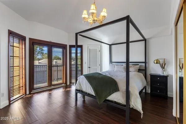 a bedroom with a bed and wooden floor