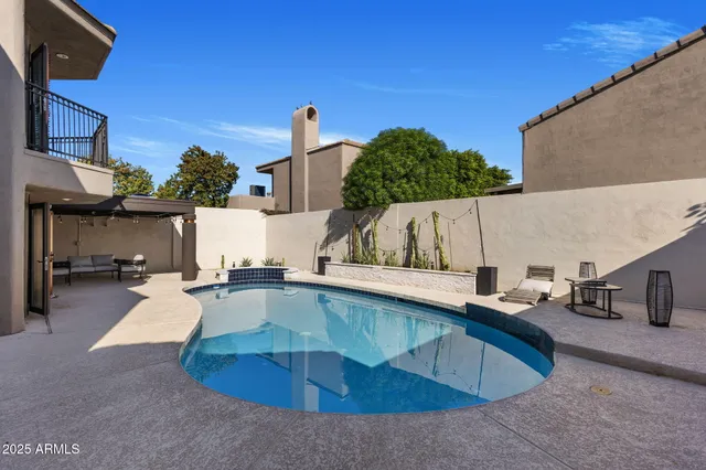 a view of a swimming pool with a patio