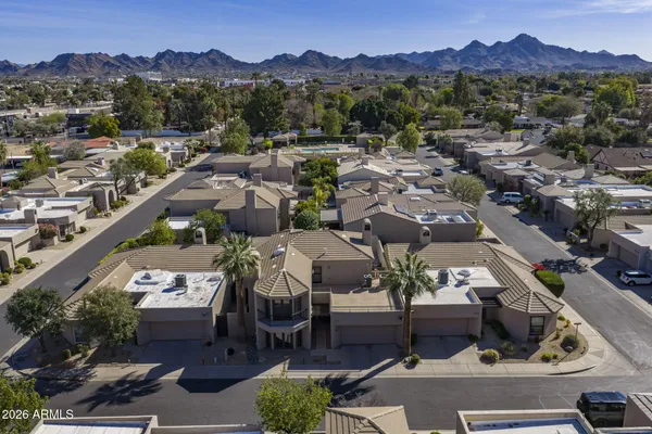 an aerial view of a house with garden space and street view