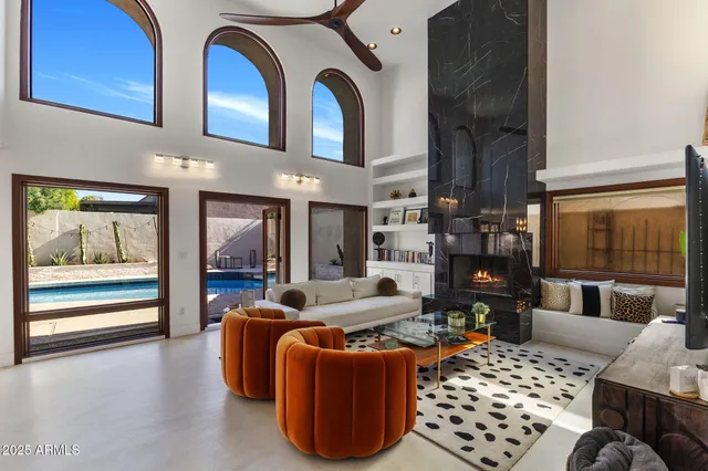 a living room with furniture a rug and white walls