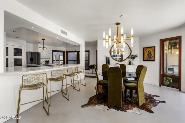 a dining room with furniture a rug and a chandelier