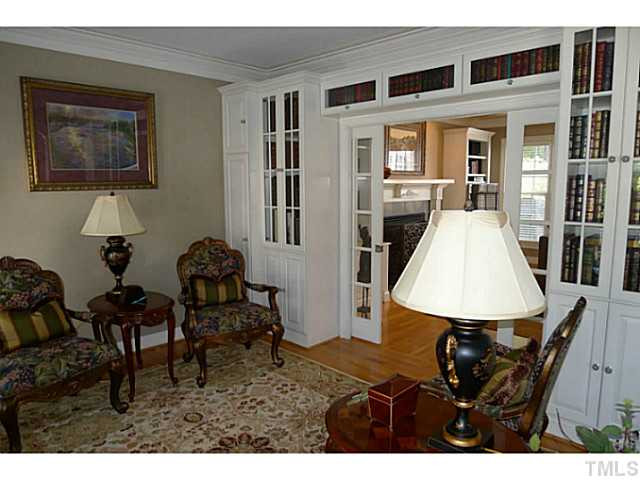 114 Lantern Ridge Lane Cary, NC 27519 - Photo 11 of 25 Formal and functional this spectacular room can serve a host of different functions ? formal living, office, library and more. Custom book / trophy cases and sliding glass pocket doors are highlights not to be missed. Living Room