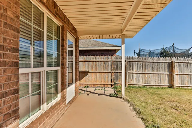 a view of a balcony with a floor to ceiling window and wooden floor