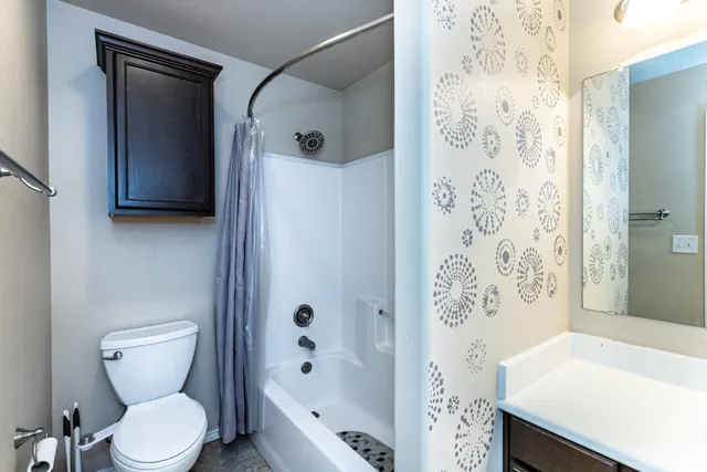 a bathroom with a sink toilet and shower