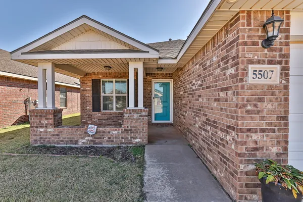 a front view of a house with outdoor seating
