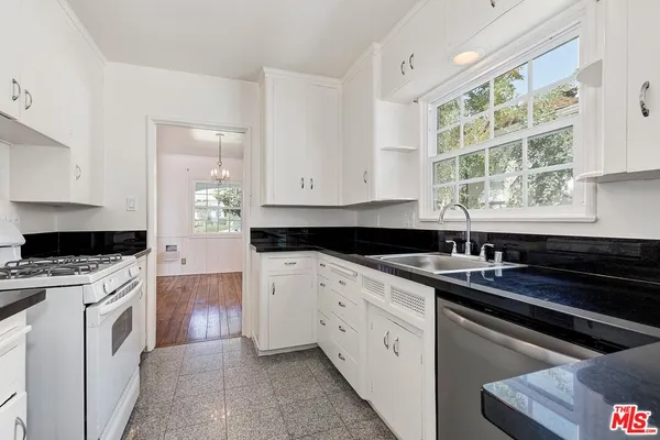 a kitchen with a sink stove and cabinets