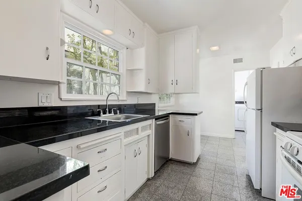 a kitchen with stainless steel appliances a sink stove and refrigerator