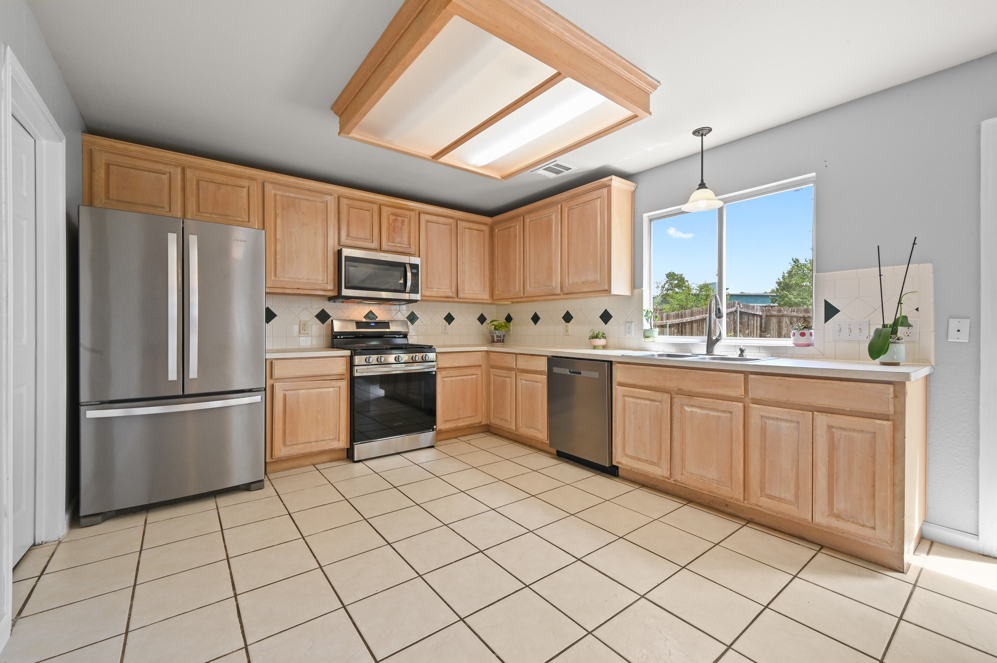 2700 Cradlerock Terrace Austin, TX 78748 - Photo 15 of 29 a kitchen with a sink a refrigerator and cabinets