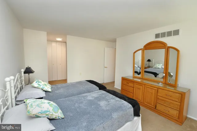 a bedroom with a bed and a dresser