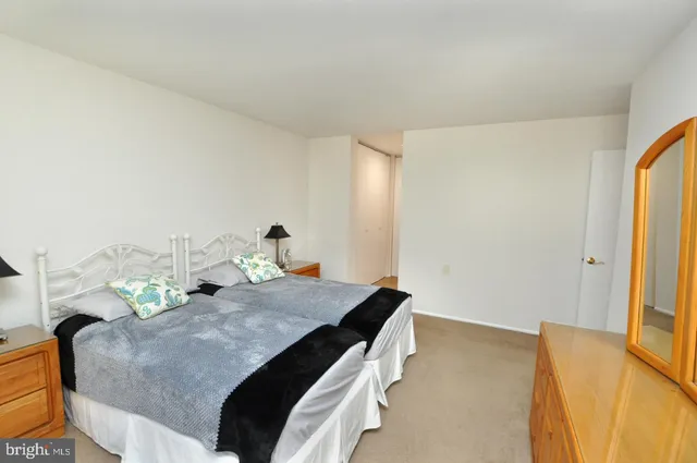 a bedroom with a bed and dresser