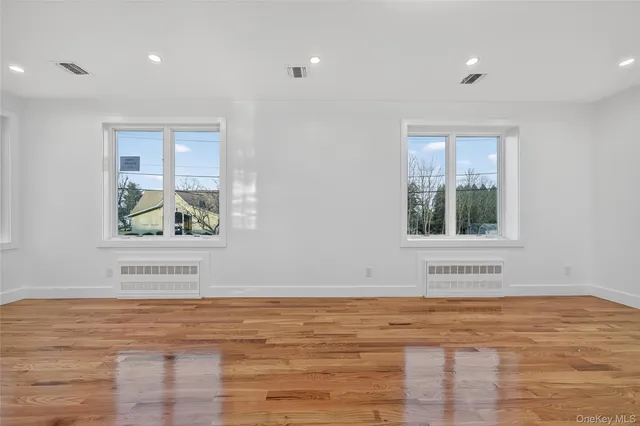 a view of an empty room and glass door