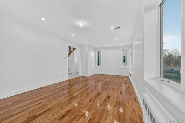 a spacious bathroom with a double vanity sink a mirror and a bathtub