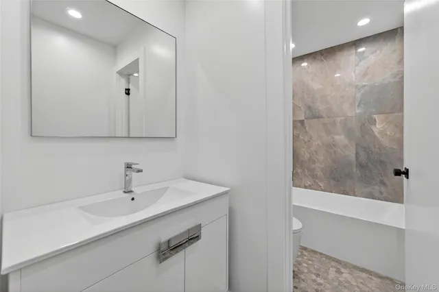 a bathroom with a bathtub and toilet