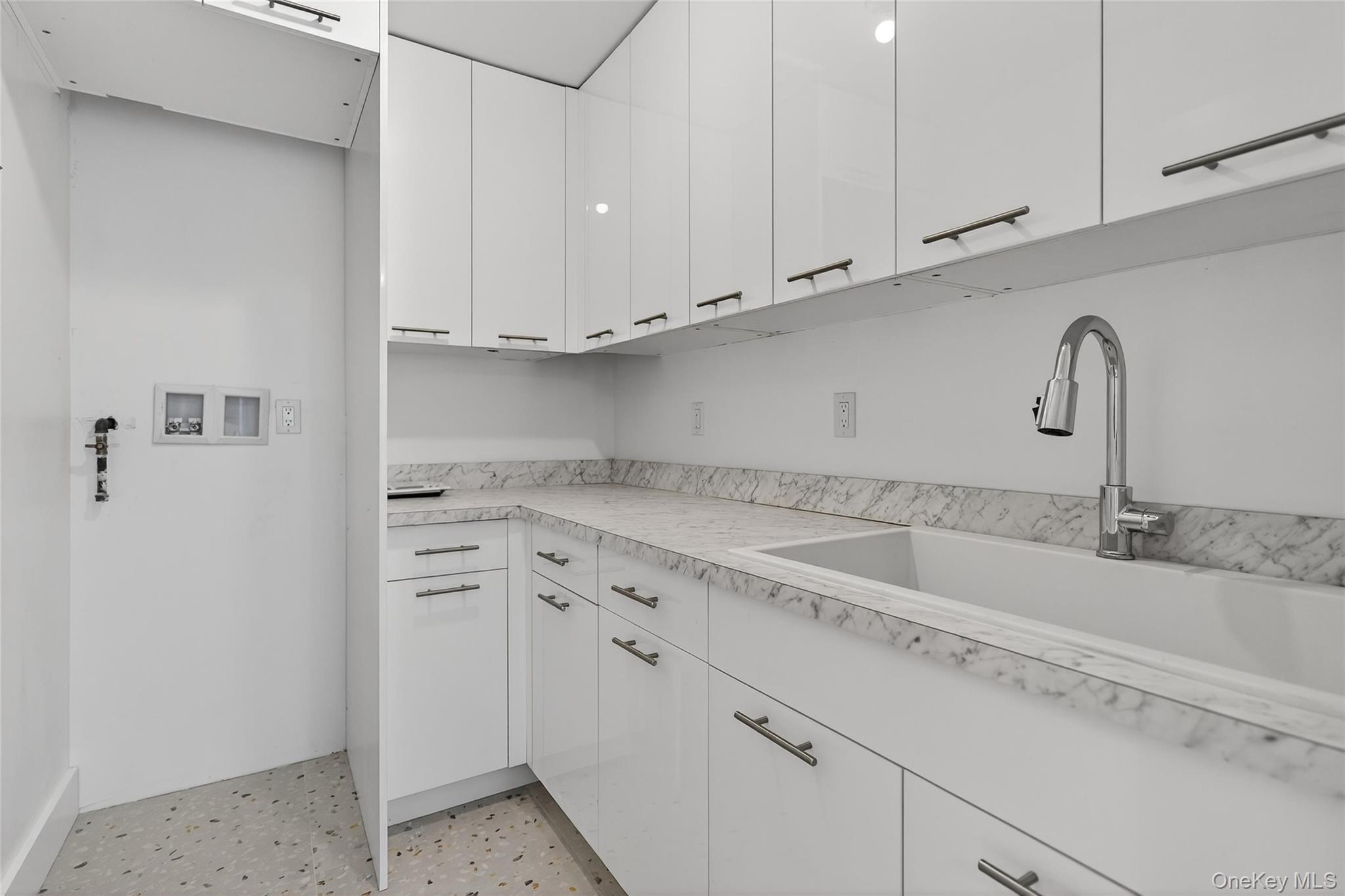 12 East Dillon Road, Unit 202 Monticello, NY 12701 - Photo 30 of 44 a kitchen with granite countertop white cabinets and a sink