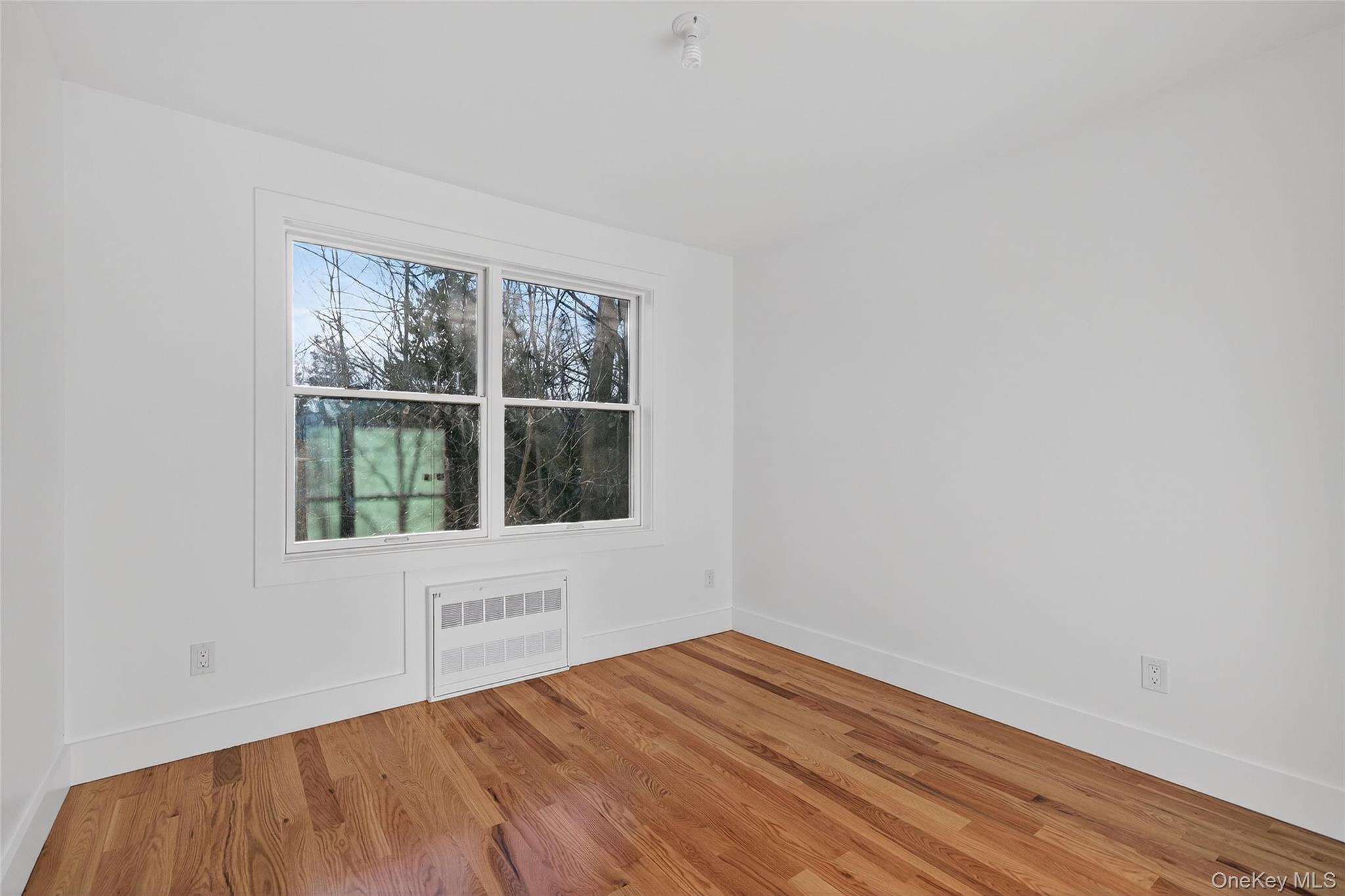 12 East Dillon Road, Unit 202 Monticello, NY 12701 - Photo 36 of 44 a view of an empty room with wooden floor and a window
