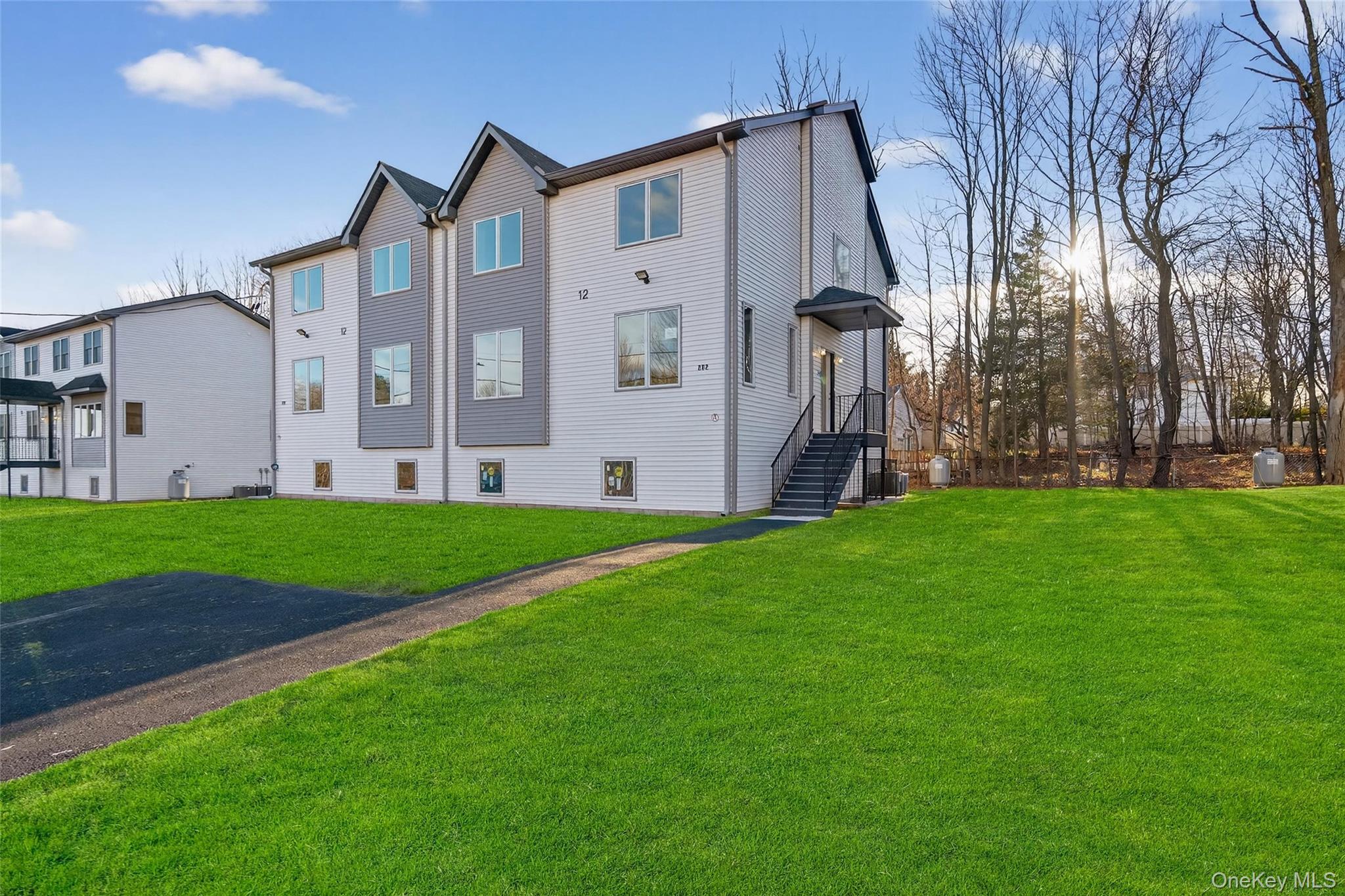 12 East Dillon Road, Unit 202 Monticello, NY 12701 - Photo 6 of 44 a front view of a house with garden