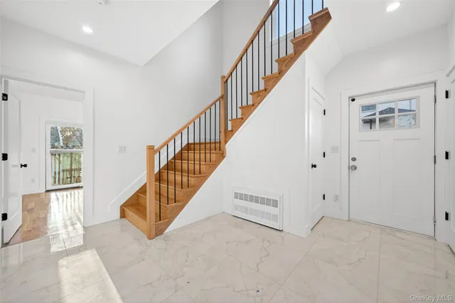 a view of entryway and hall with wooden floor
