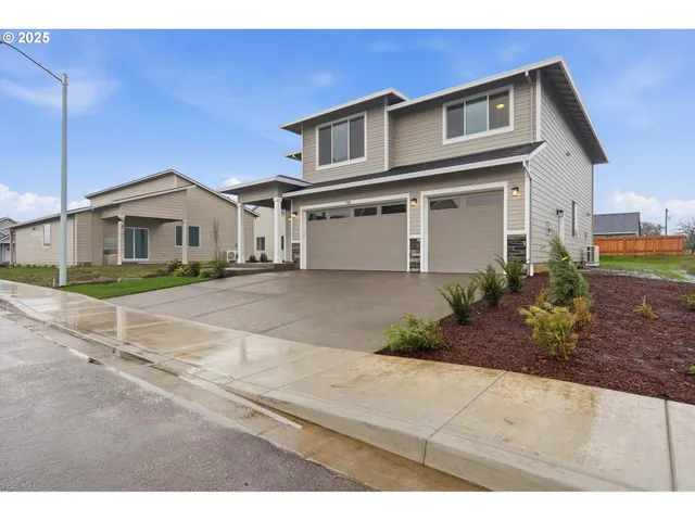 a front view of a house with a garden