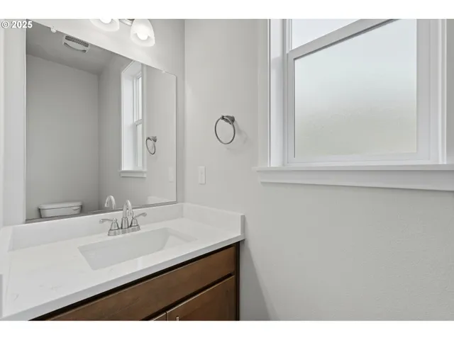 a bathroom with a sink vanity and a mirror