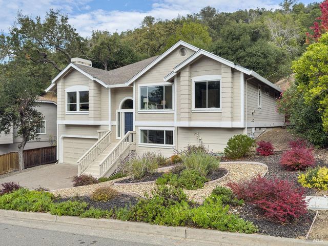a front view of a house with a yard and garage