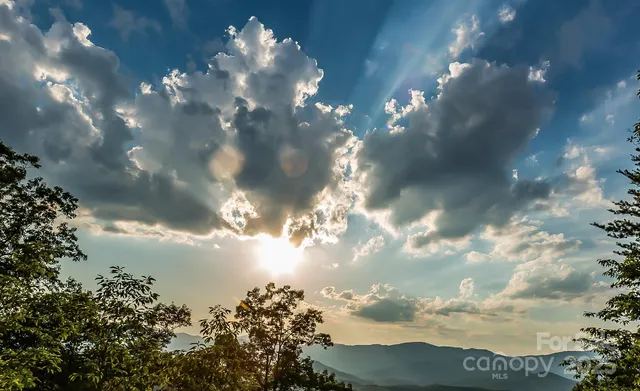 a view of a lake in middle of sunset