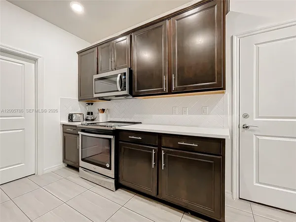 a kitchen with stainless steel appliances granite countertop a sink and a stove
