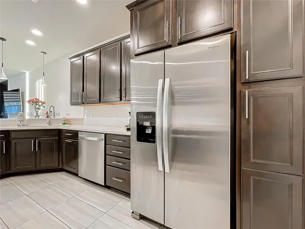 a kitchen with stainless steel appliances granite countertop a sink and cabinets