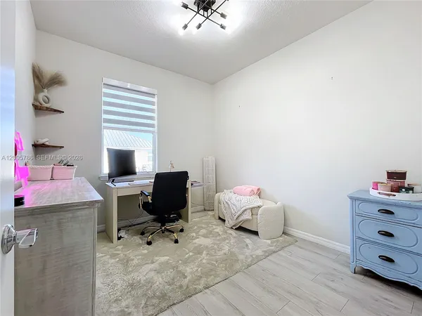 a bedroom with a bed a chandelier and closet