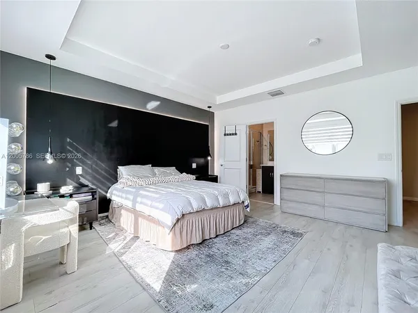 a bedroom with a bed and a couch