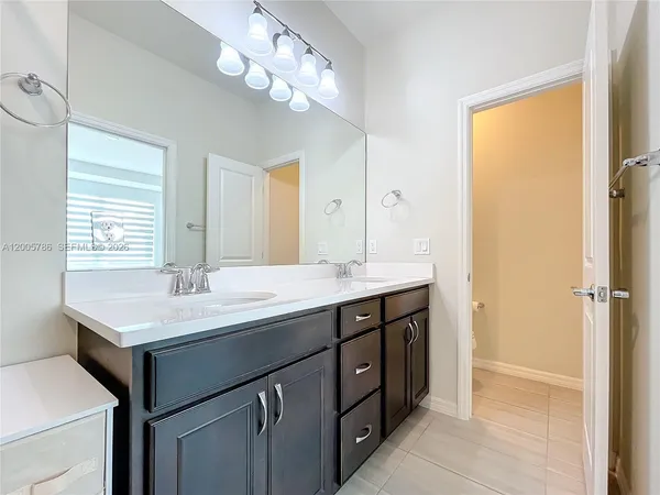 a white toilet sitting next to a bathroom sink