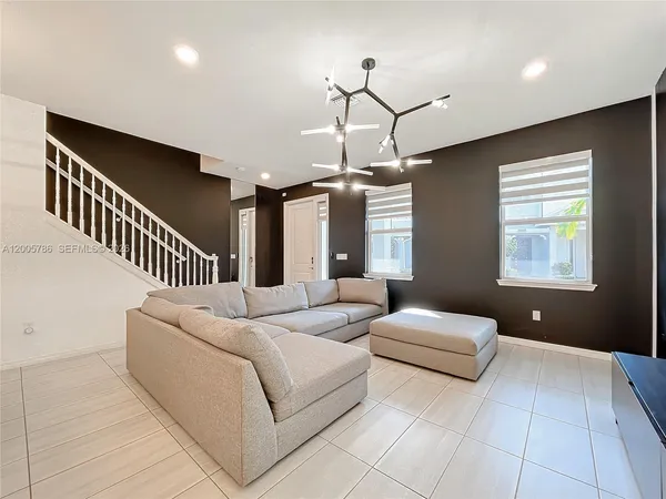 a living room with furniture ceiling and a ceiling fan