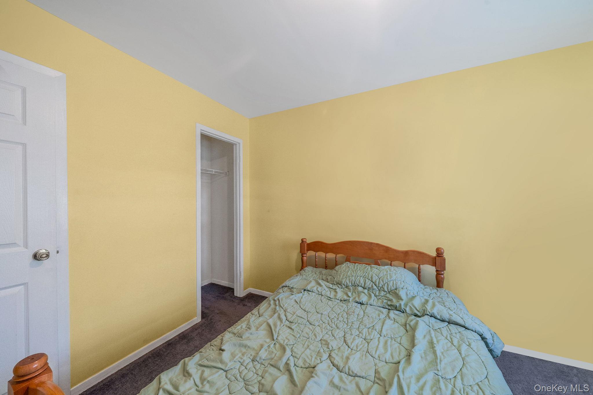 1169 Little E Neck Road West Babylon, NY 11704 - Photo 14 of 28 a bedroom with a bed and a mirror