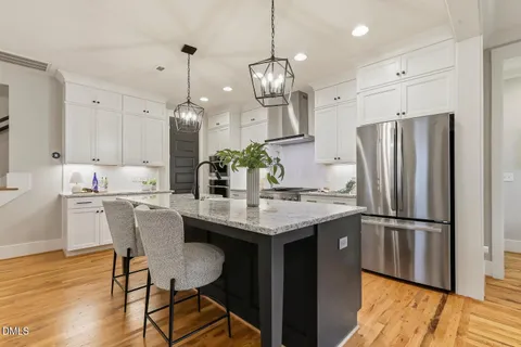 a kitchen with stainless steel appliances granite countertop stove top oven and refrigerator