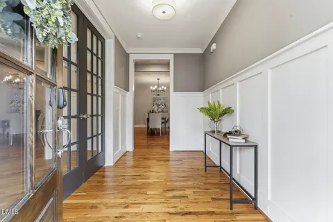 a dining room with furniture a rug and white walls