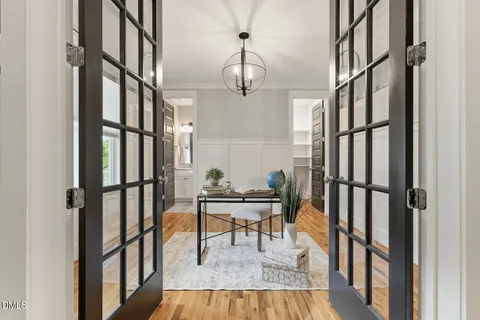 a view of a dining room with furniture wooden floor and a chandelier